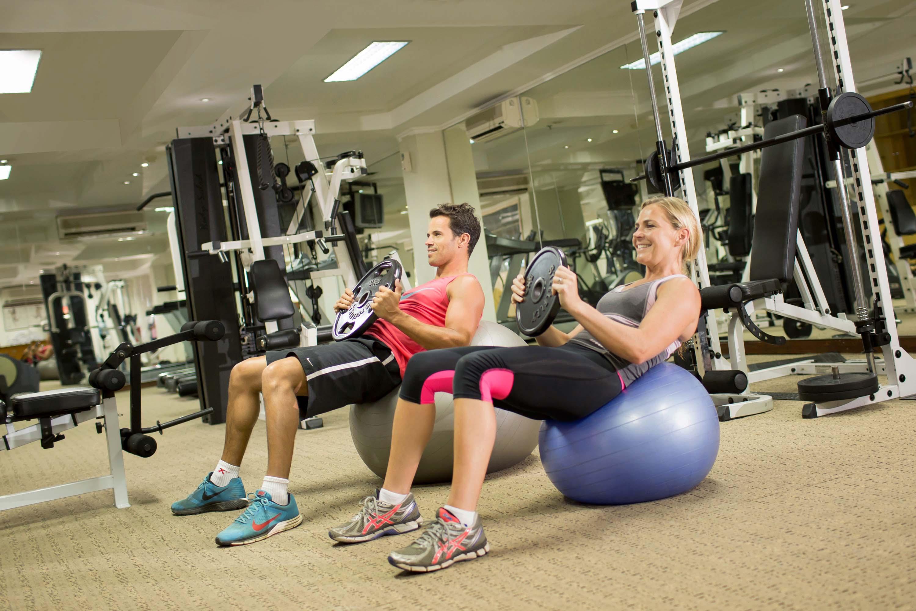 Bali Dynasty Resort Кута Екстер'єр фото A man and woman exercising with a Swiss ball